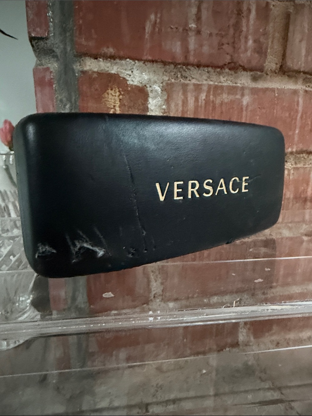 Black Versace clamshell sunglasses case